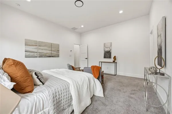a bedroom with a bed and a chair