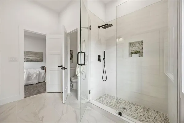 a bathroom with a glass shower door