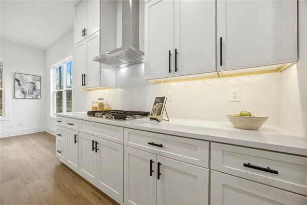 a kitchen with white cabinets and a sink