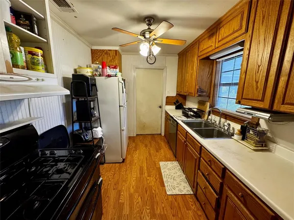 a kitchen with a sink appliances and cabinets