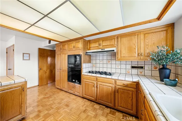 a kitchen with sink and refrigerator