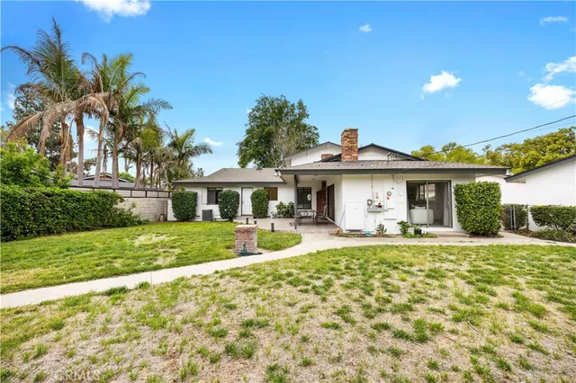a front view of a house with a yard and porch