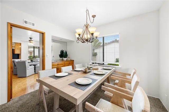 a view of a dining room with furniture and chandelier