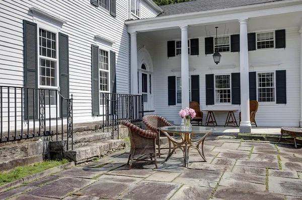 a table and chairs in front of a house
