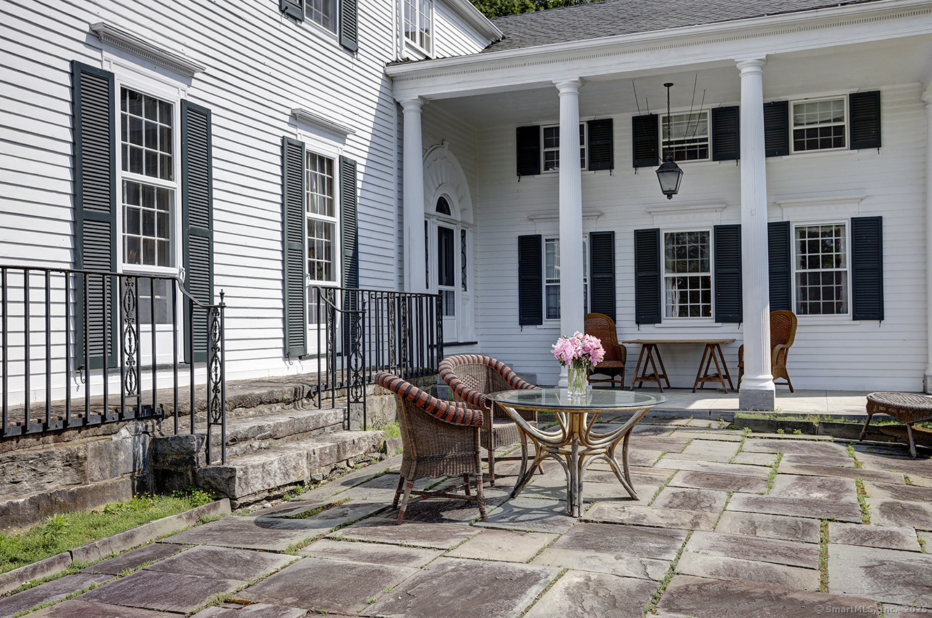 127 Old Goshen Road Norfolk, CT 06058 - Photo 14 of 32 a table and chairs in front of a house