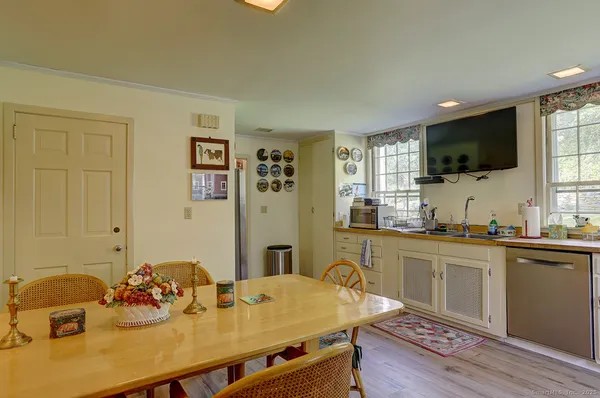 a kitchen with a sink cabinets and wooden floor