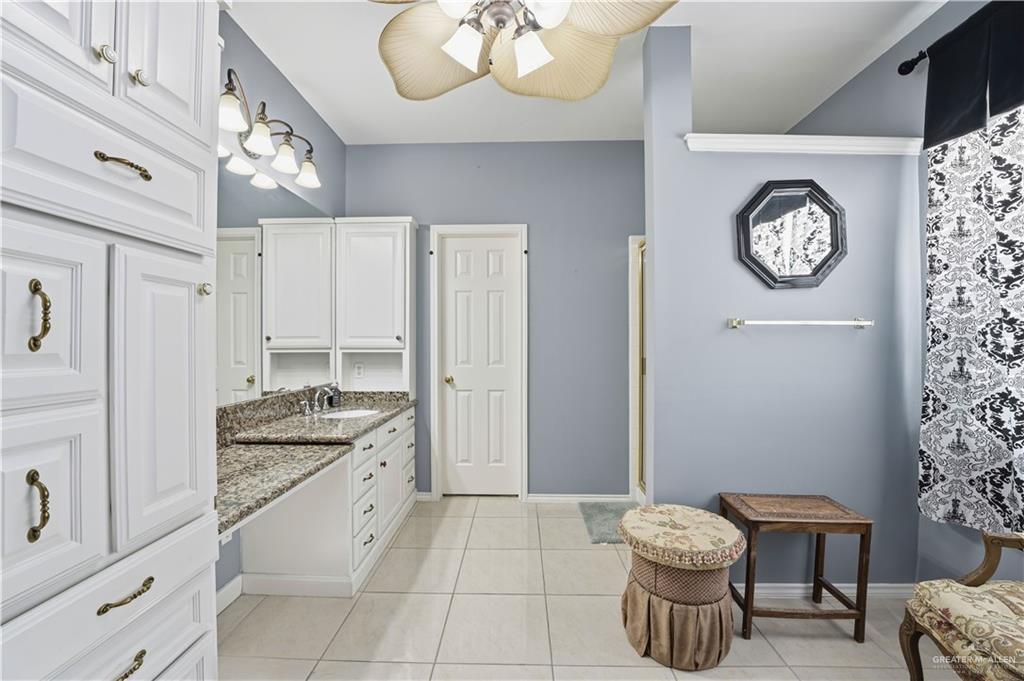 2804 Santa Lydia Street Mission, TX 78572 - Photo 11 of 18 a spacious bathroom with a granite countertop sink a toilet and a mirror