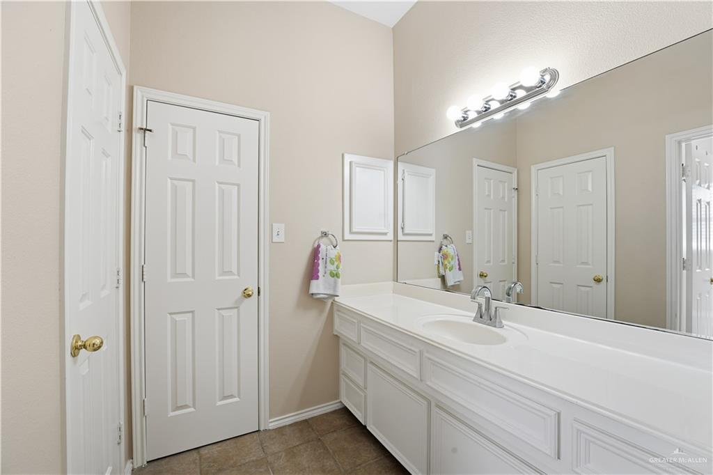 2804 Santa Lydia Street Mission, TX 78572 - Photo 14 of 18 a bathroom with a double vanity sink and a mirror