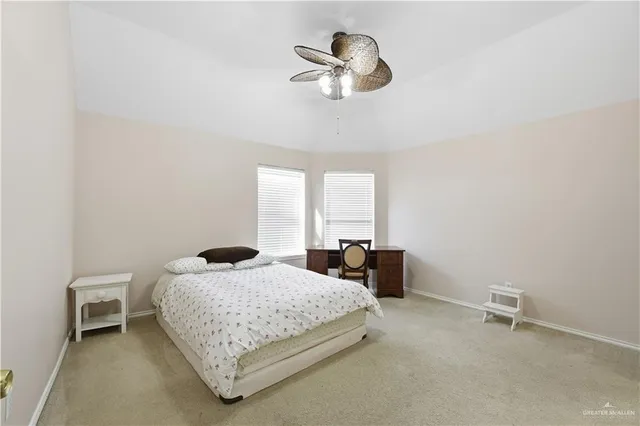 an empty room with closet and a ceiling fan