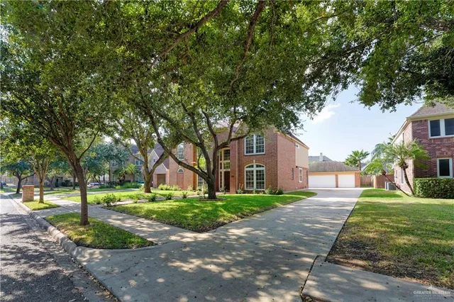 a front view of a building with trees and trees