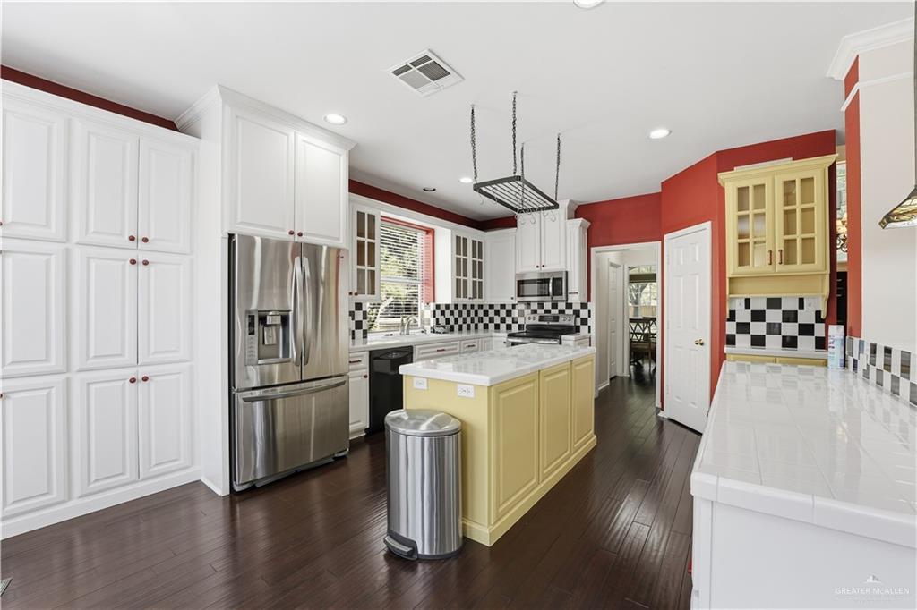 2804 Santa Lydia Street Mission, TX 78572 - Photo 8 of 18 a kitchen with stainless steel appliances a refrigerator a stove a sink and a wooden floors