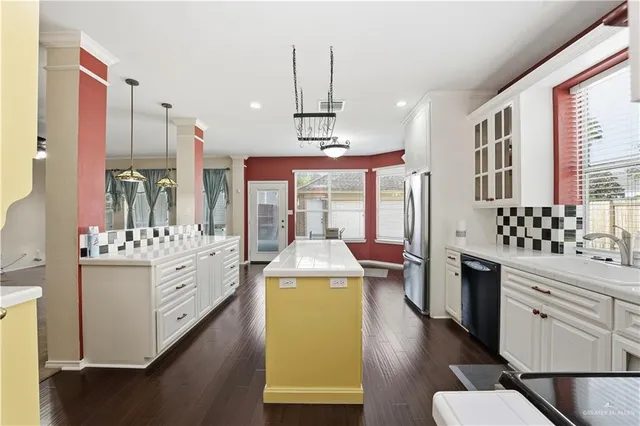 an empty room with a chandelier fan and closet area