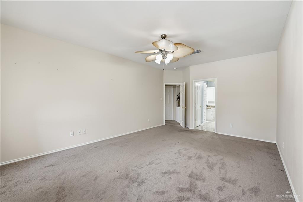 2804 Santa Lydia Street Mission, TX 78572 - Photo 10 of 18 an empty room with a chandelier fan and closet area