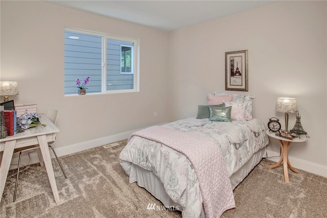 22222 17th Avenue West, Unit 8 Bothell, WA 98021 - Photo 22 of 38 a bedroom with a bed a window and wall painting