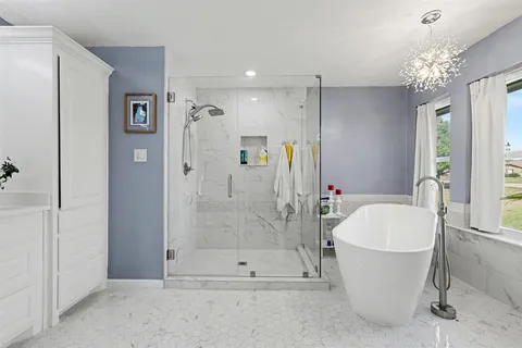 a bathroom with a granite countertop sink a toilet and shower
