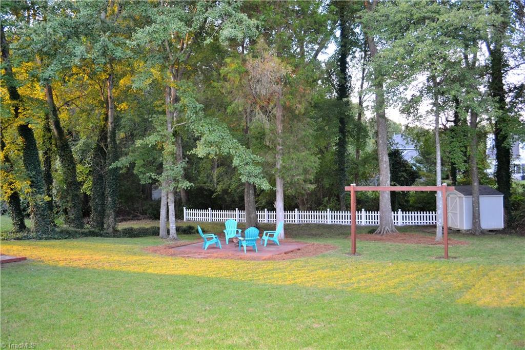 3313 Timberwolf Avenue High Point, NC 27265 - Photo 23 of 25 View from the driveway. Lovely backyard with storage building, Fire pit, mature trees and a small creek.