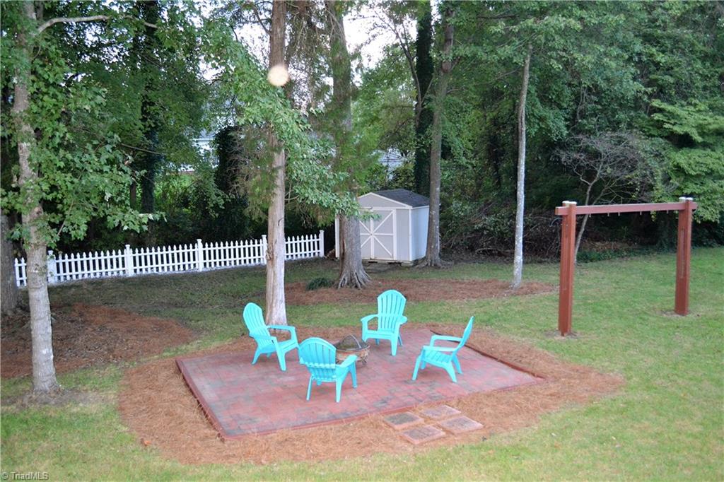 3313 Timberwolf Avenue High Point, NC 27265 - Photo 24 of 25 Nice brick patio for relaxing around a fire in the cool fall evenings. Just add swings to the existing frame and have fun relaxing evenings for the whole family.