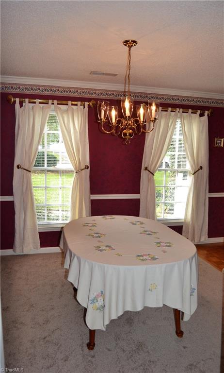 3313 Timberwolf Avenue High Point, NC 27265 - Photo 5 of 25 Formal dining room with new carpet and beautiful windows.