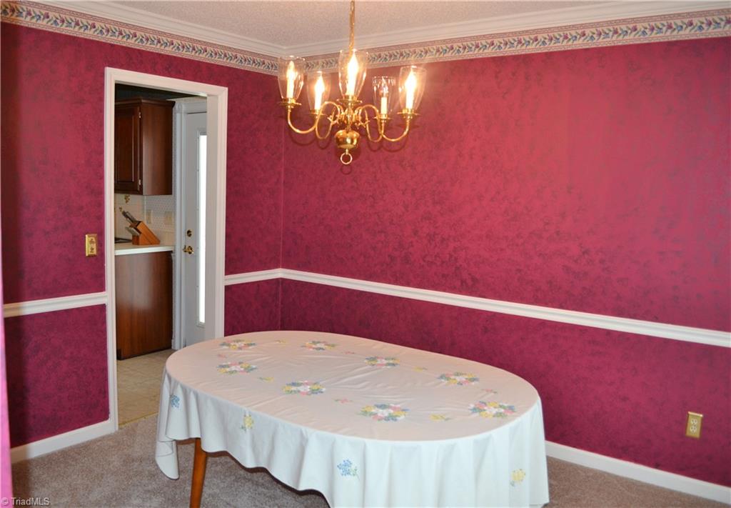 3313 Timberwolf Avenue High Point, NC 27265 - Photo 6 of 25 Formal dining room opens to the kitchen.