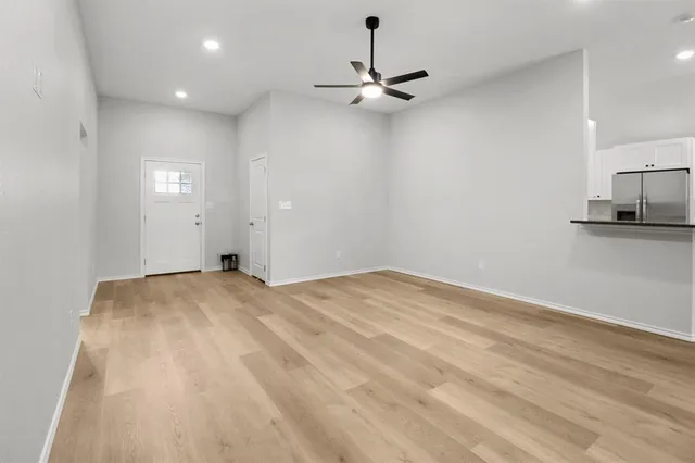 a view of a kitchen with a sink and a refrigerator