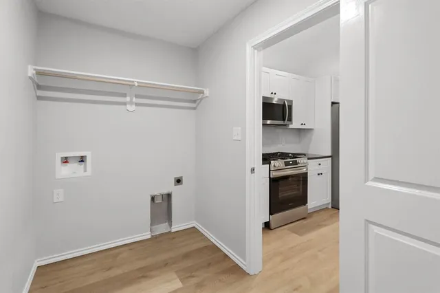 a kitchen with a refrigerator and a stove top oven