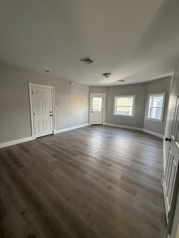 72 Belmont Street, Unit 3 FRONT Fall River, MA 02720 - Photo 4 of 8 a view of empty room with window and wooden floor