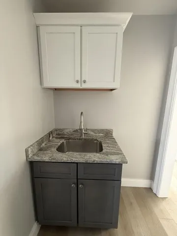 a kitchen with a sink and cabinets