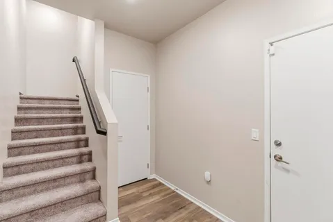 a view of entryway with stairs and wooden floor