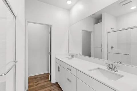 a bathroom with a double vanity sink mirror and double
