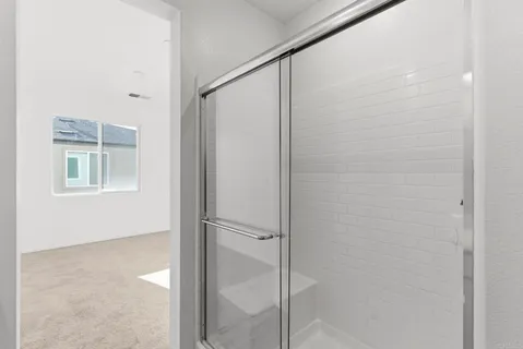 a bathroom with a glass shower door