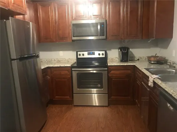 a kitchen with a stove and a refrigerator