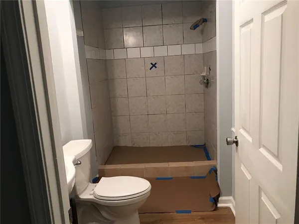 a bathroom with a granite countertop bathtub and toilet