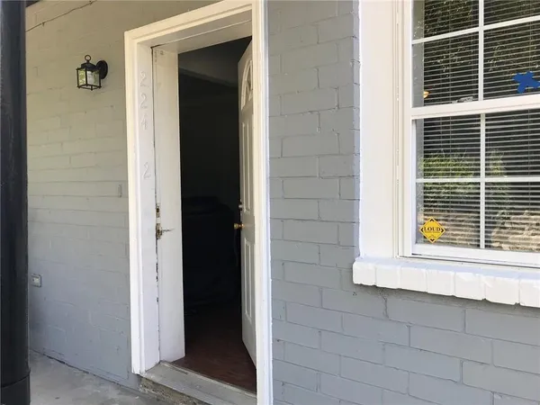 a view of front door and deck of the house