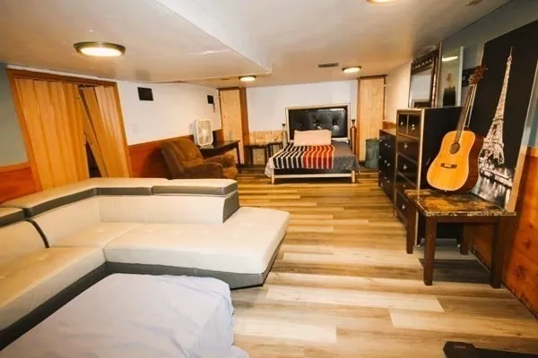 a living room with furniture a table and a chandelier