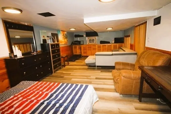 a living room with furniture a flat screen tv and a fireplace