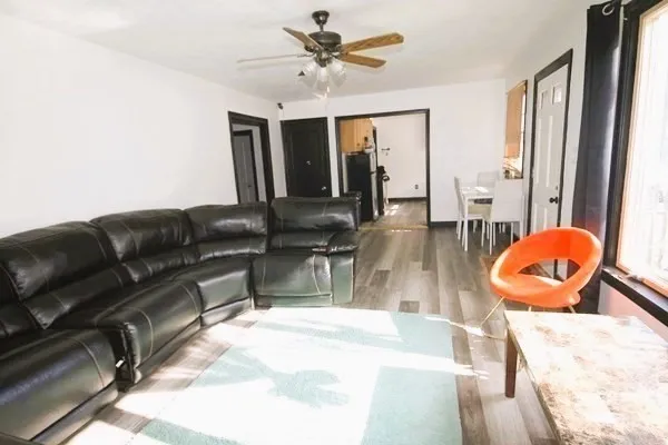 a bedroom with a bed and a flat tv screen on the dresser
