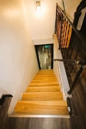 a bedroom with a bed a couch and a chandelier