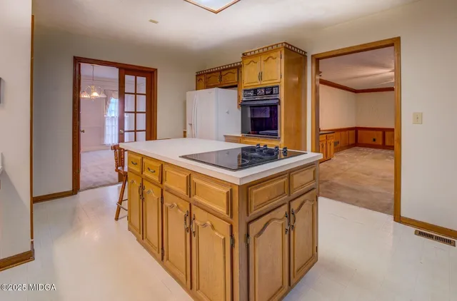 a kitchen with stainless steel appliances granite countertop a stove and a refrigerator
