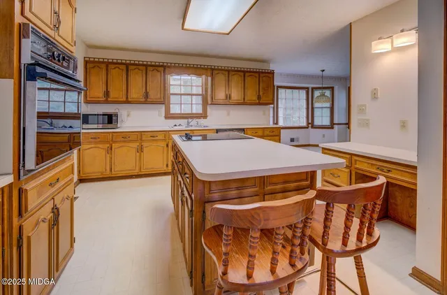 a kitchen with stainless steel appliances granite countertop a stove a sink and a refrigerator