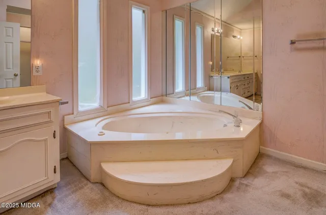 a bathroom with bathtub and window