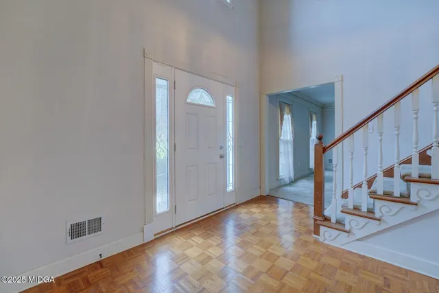 a view of an entryway with wooden floor