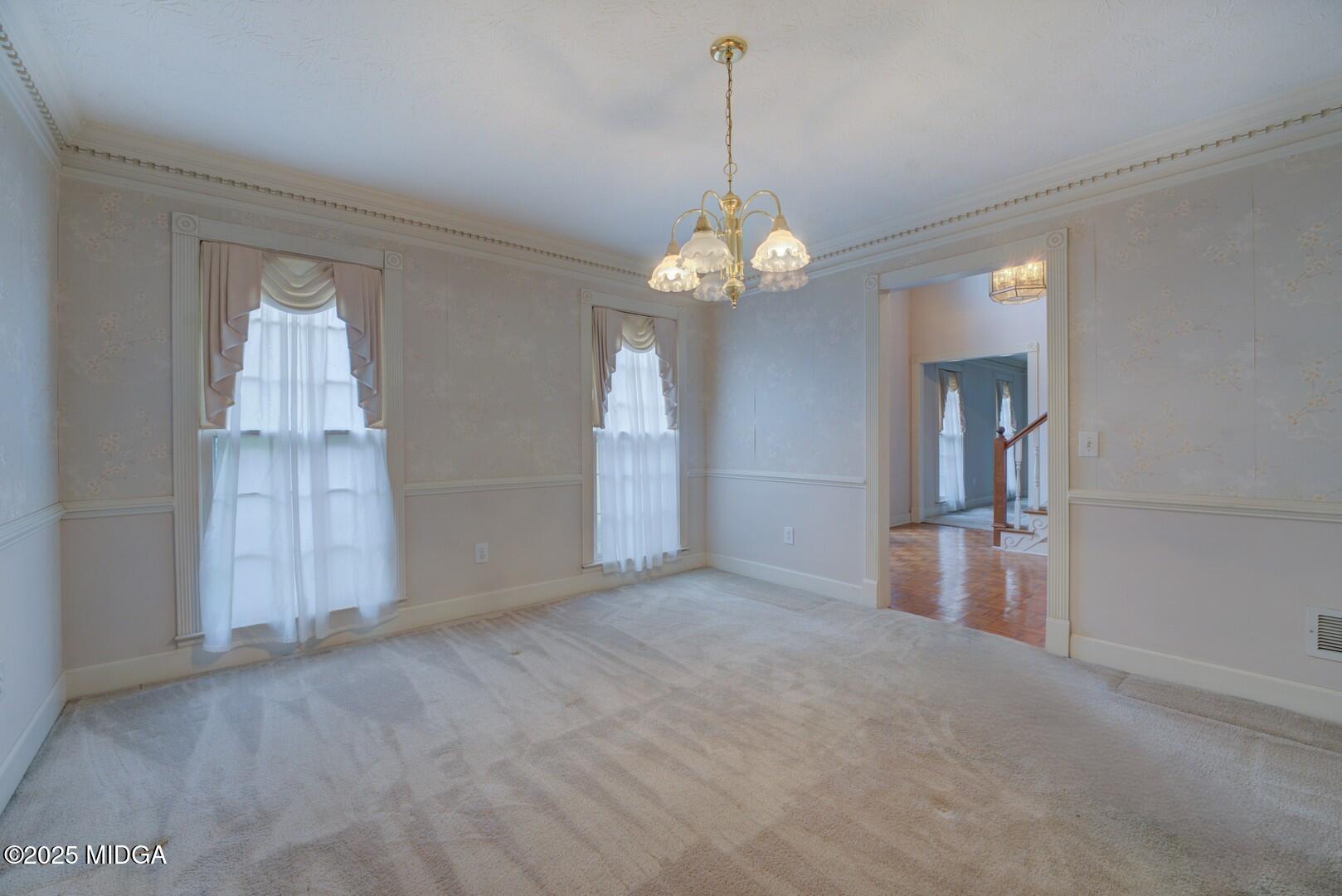 5633 Fox Den Trail Lithonia, GA 30038 - Photo 10 of 44 an empty room with chandelier and windows