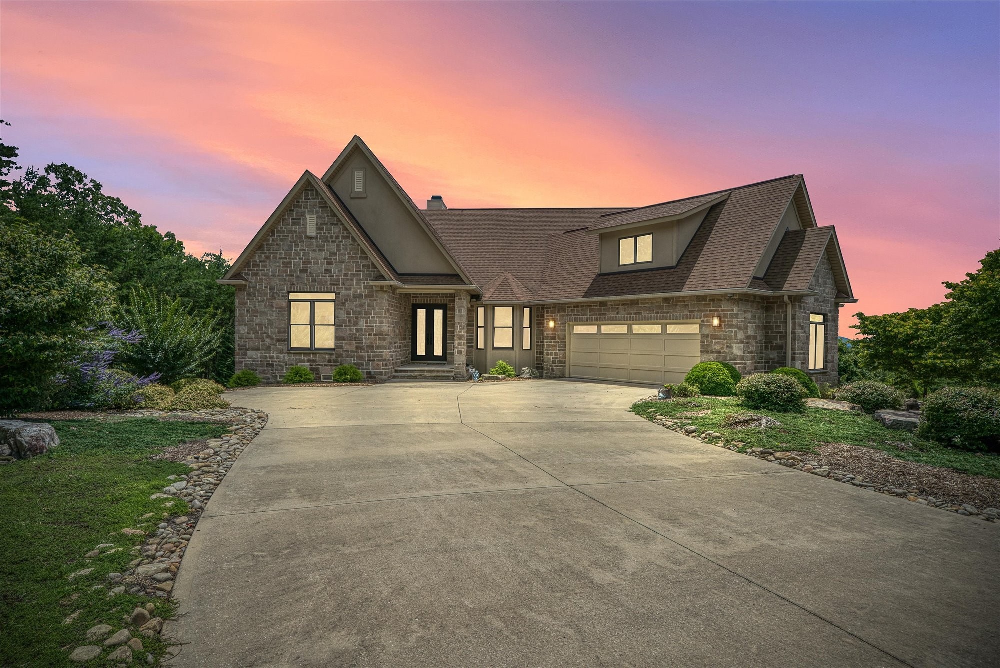 a front view of a house with a yard and garage
