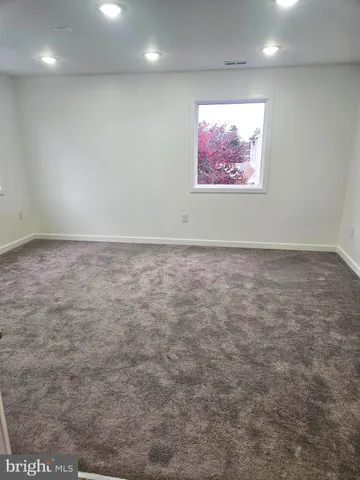 an empty room with a painting on the wall