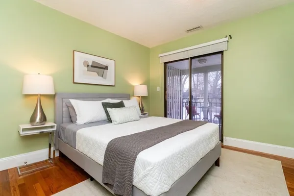 a bedroom with a bed and a lamp