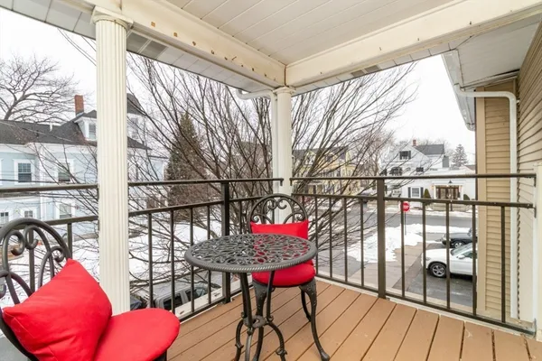 a balcony with table and chairs