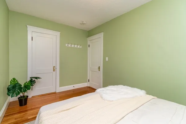 a bedroom with a bed and a potted plant