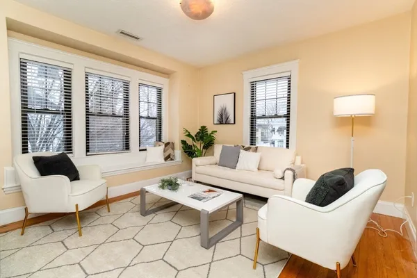 a living room with furniture and floor to ceiling windows