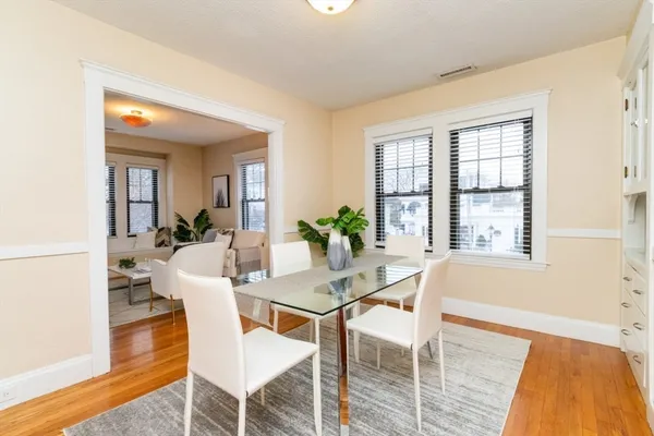 a dining room with furniture and wooden floor