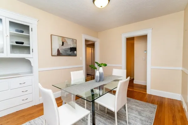 a view of a dining room with furniture and wooden floor